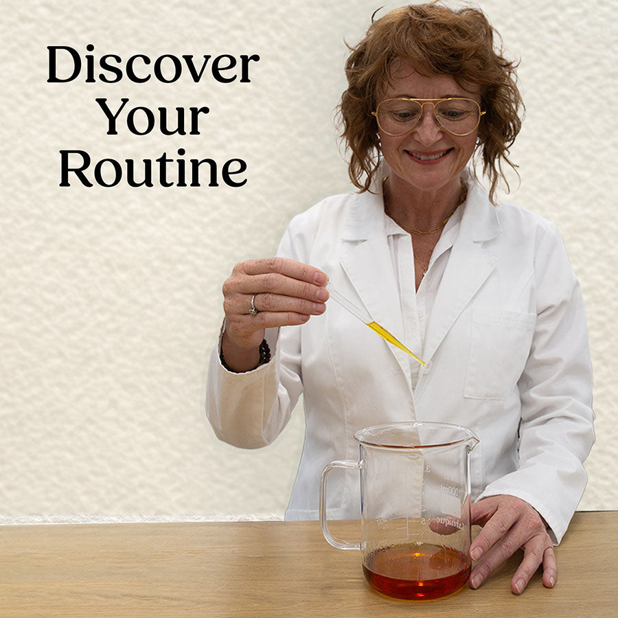 Simple Body Founder, Jewels Burdick in a lab coat holding a test tube with a beaker of Age Defense Serum and an off white background