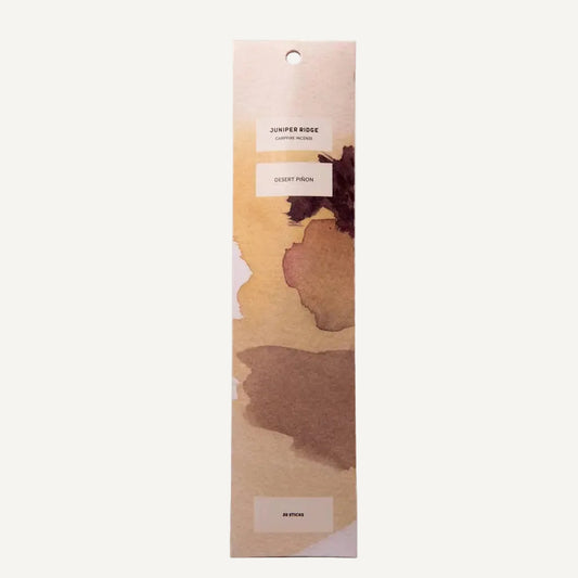 Juniper Ridge Campfire Incense iin Desert Pinon with a watercolor floral design package on a white background
