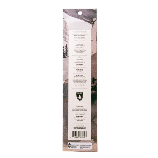 Juniper Ridge Campfire Incense in Cedar Product packaging with a scenic background and text on a white background