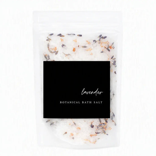A clear stand-up pouch of lavender botanical bath salt with a large black label reading 'lavender BOTANICAL BATH SALT' on a white background.