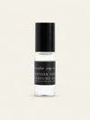 A clear glass bottle of Lavender Thyme Perfume Oil with a black cap and black label, showing the clear oil inside, set against a solid off-white background.