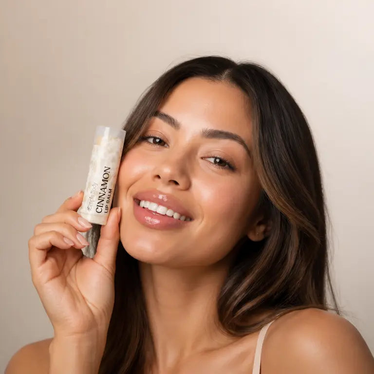 A woman holds a Simple Body Lip Balm Tube. AI