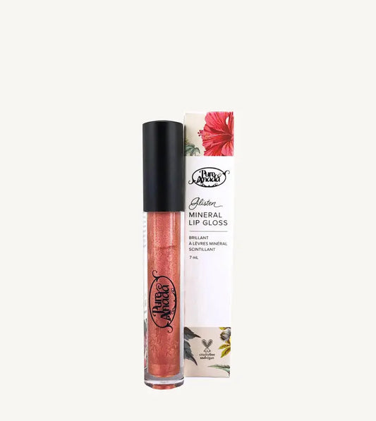 A photo of Pure Anada's Mineral Lip Gloss in Rose Gold with the tube standing up with a black lid and filled with a shimmery red - orange liquid on a tan background.
