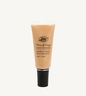 A photo of Pure Anada's Liquid Concealer in Light which is a warm beige color on a tan background.