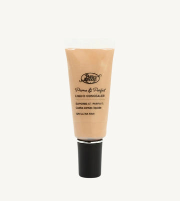 A photo of Pure Anada's Liquid Concealer in Ultra Fair which is a warm beige with yellow undertones on a tan background.