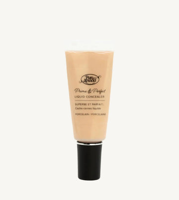 A photo of Pure Anada's Liquid Concealer in Porcelain which is a very light beige color on a tan background.