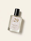 A bottle of Luxe Perfume No. 29 with a beige label that reads "Amber Wood Vanilla" on a beige background.