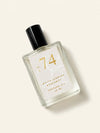 A bottle of Luxe Perfume No. 74 with a beige label that reads "White Jasmine Bergamot Perfume Oil" on a beige background.