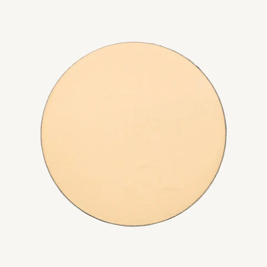 A photo of Pure Anada's Pressed Translucent Setting Powder in Matte which is a light yellow / pink color on a tan background.