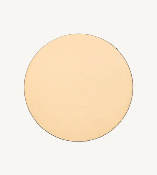 A photo of Pure Anada's Pressed Translucent Setting Powder in Matte which is a light yellow / pink color on a tan background.