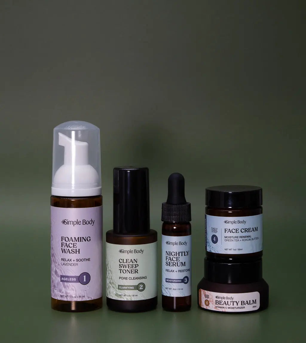 A Mini Starter Skincare kit for acne prone skin including a Foaming Face Wash, Clean Sweep Toner, Nightly Face Serum, Face Cream, and Beauty Balm a dark green background.