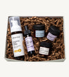 A Simple Body Mini Facial Kit that includes a Chamomile Foaming Face Wash Calm and Balance, Eye Defense Serum to Revitalize and Brighten, Face Cream for Moisture Renewal with Green Tea, Bamboo Face Polish Exfoliating Cleansing Scrub, and Beauty Balm Vitamin C Super Boosting Moisturizer with kraft shred on a white background
