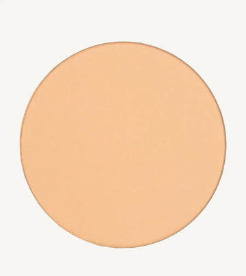 A photo of Pure Anada's Pressed Sheer Foundation in Very Fair which is a medium beige with light overtones and a warm feel on a tan background.