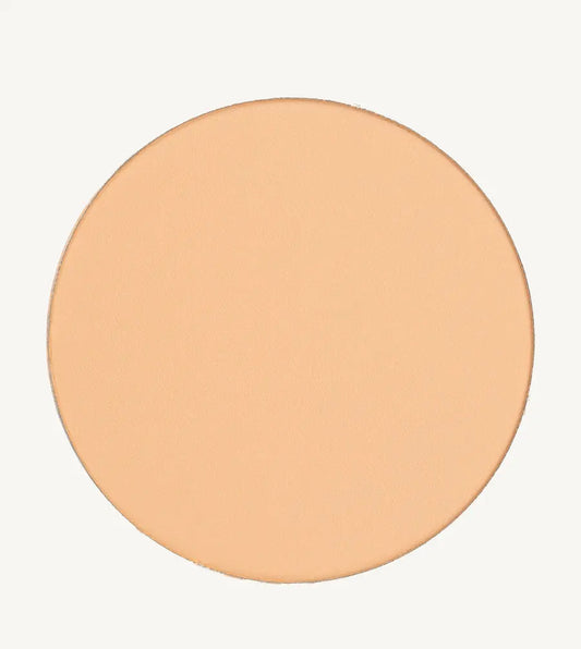A photo of Pure Anada's Pressed Sheer Foundation in Very Fair which is a medium beige with light overtones and a warm feel on a tan background.