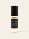 A bottle of Sandalwood Noir 49 Perfume Oil by Benjamin Soap Co, featuring a black cap and a black label with white text, set against a solid light beige background.