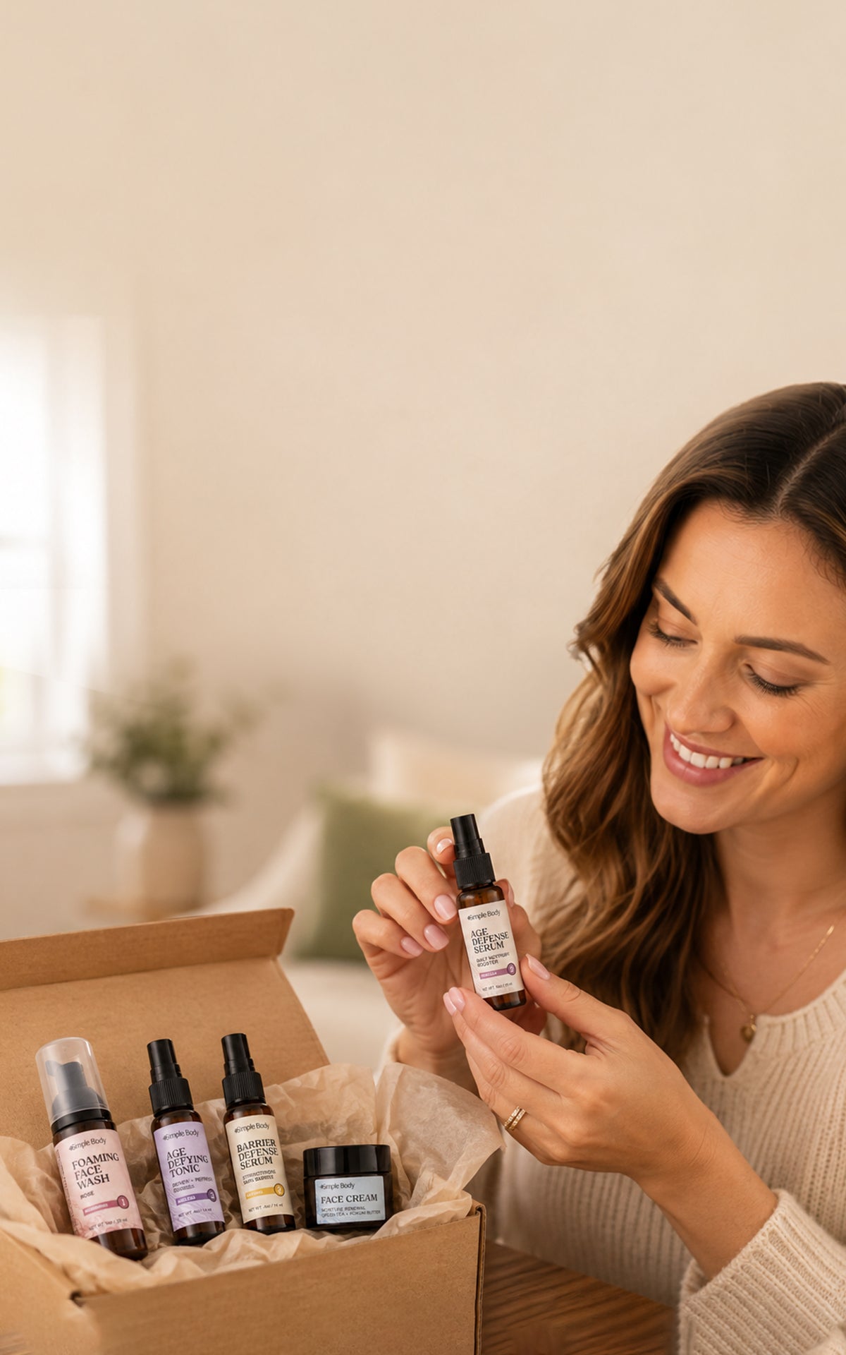 Woman holding Simple Body Age Defense Serum with a trial-size skincare collection in a gift box