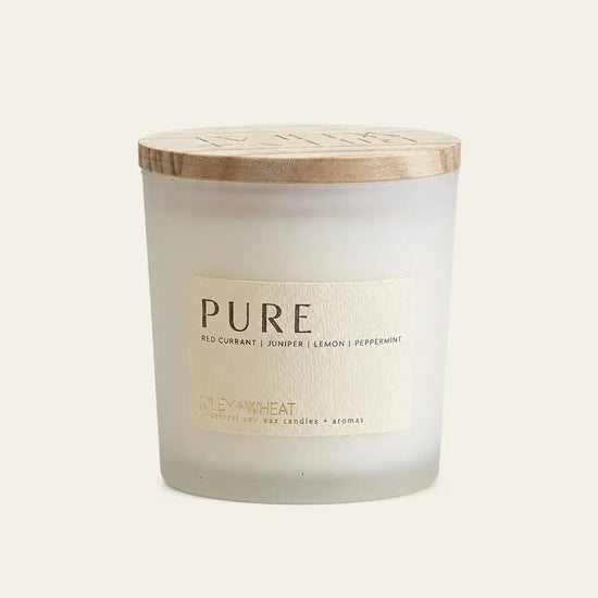 A single candle by Riley + Wheat called Pure with a description of Red currant, juniper, lemon, and peppermint on a white background.