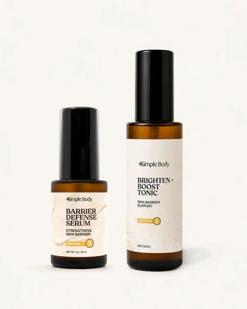 Two Simple Body skincare bottles on a clean white background: a smaller amber bottle of Barrier Defense Serum with a black cap and cream label, and a taller amber bottle of Brighten + Boost Tonic with a black cap and white label.