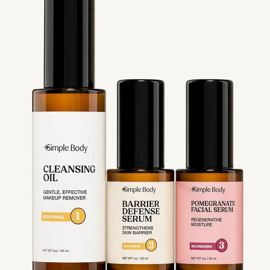 Three Simple Body skincare bottles on a light beige background: Cleansing Oil, Barrier Defense Serum, and Pomegranate Facial Serum.