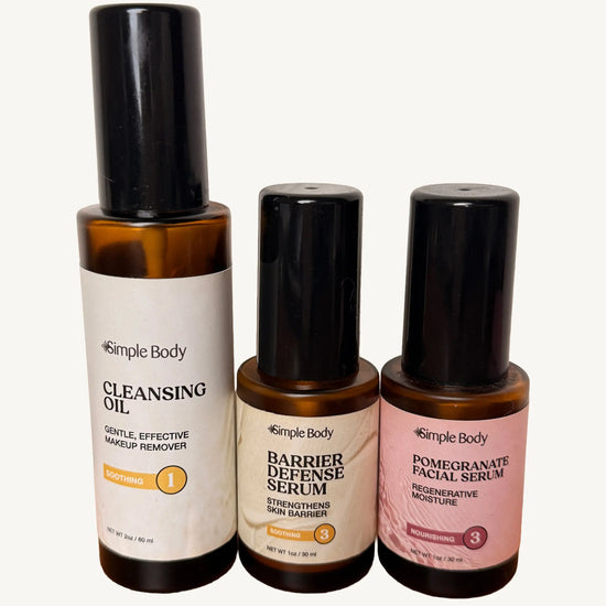 A clean photo of Simple Body Cleansing Oil, Simple Body Barrier Defense Serum, and Simple Body Pomegranate Oil on a white background.