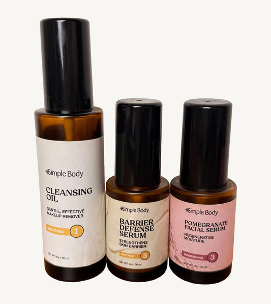 A clean photo of Simple Body Cleansing Oil, Simple Body Barrier Defense Serum, and Simple Body Pomegranate Oil on a white background.