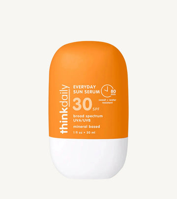 Orange and white sunscreen bottle with 'think daily' branding on a white background
