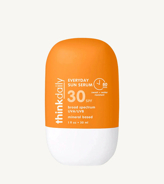 Orange and white sunscreen bottle with 'think daily' branding on a white background