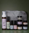 Skincare Kit designed for acne prone skin with a gray pouch on a green background