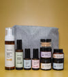 A skincare kit for sensitive skin with a gray pouch on a yellow background