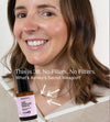 A woman smiling with beautiful skin and a bottle of Simple Body Age Defying Serum a testimonial on a white background.