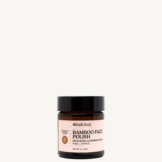 A jar of Simple Body Bamboo Face Polish with the label showing the product name and the scents, rose and orange.
