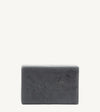 A handmade bar of soap with a gray color and an embossed design on it, placed against a white background.