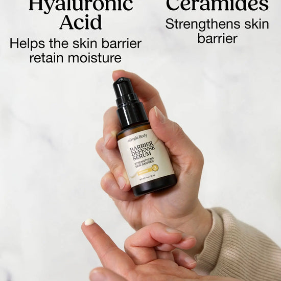 Hand holding a bottle of Simple Body Barrier Defense Serum with text about Hyaluronic Acid and Ceramides on a white background