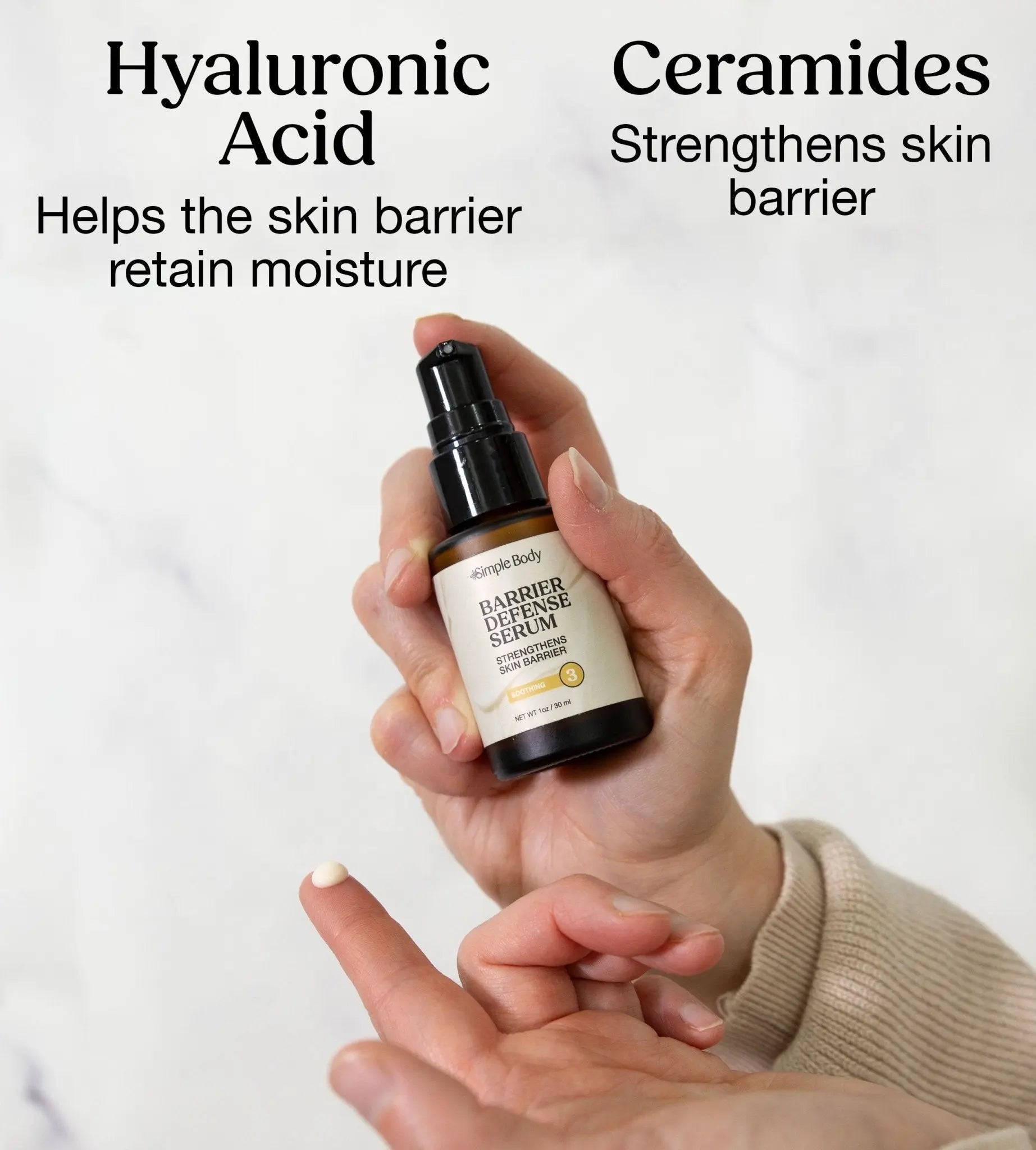 Hand holding a bottle of Simple Body Barrier Defense Serum with text about Hyaluronic Acid and Ceramides on a white background