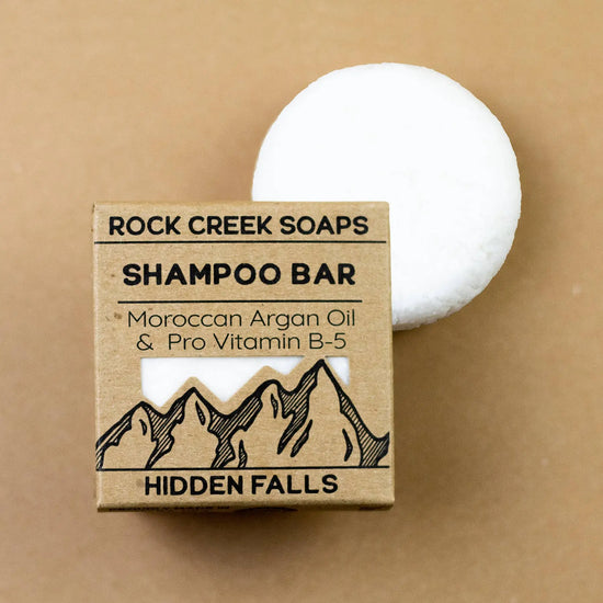 Rock Creek Soaps shampoo bar with packaging on a beige background