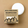 Rock Creek Soaps shampoo bar with packaging on a beige background