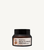 Beauty balm jar with black lid and peach colored label on a light tan background