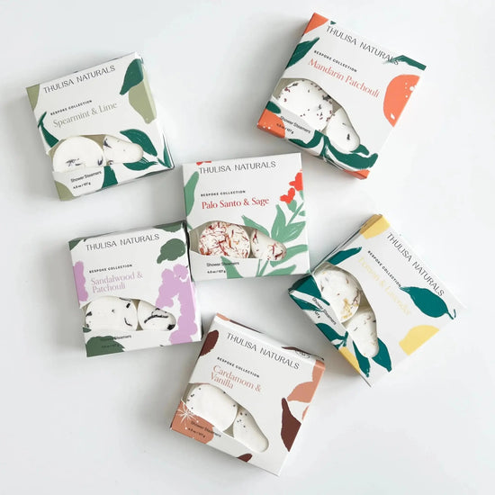Collection of Thulisa Naturals Shower Steamer Gift boxes on a white background