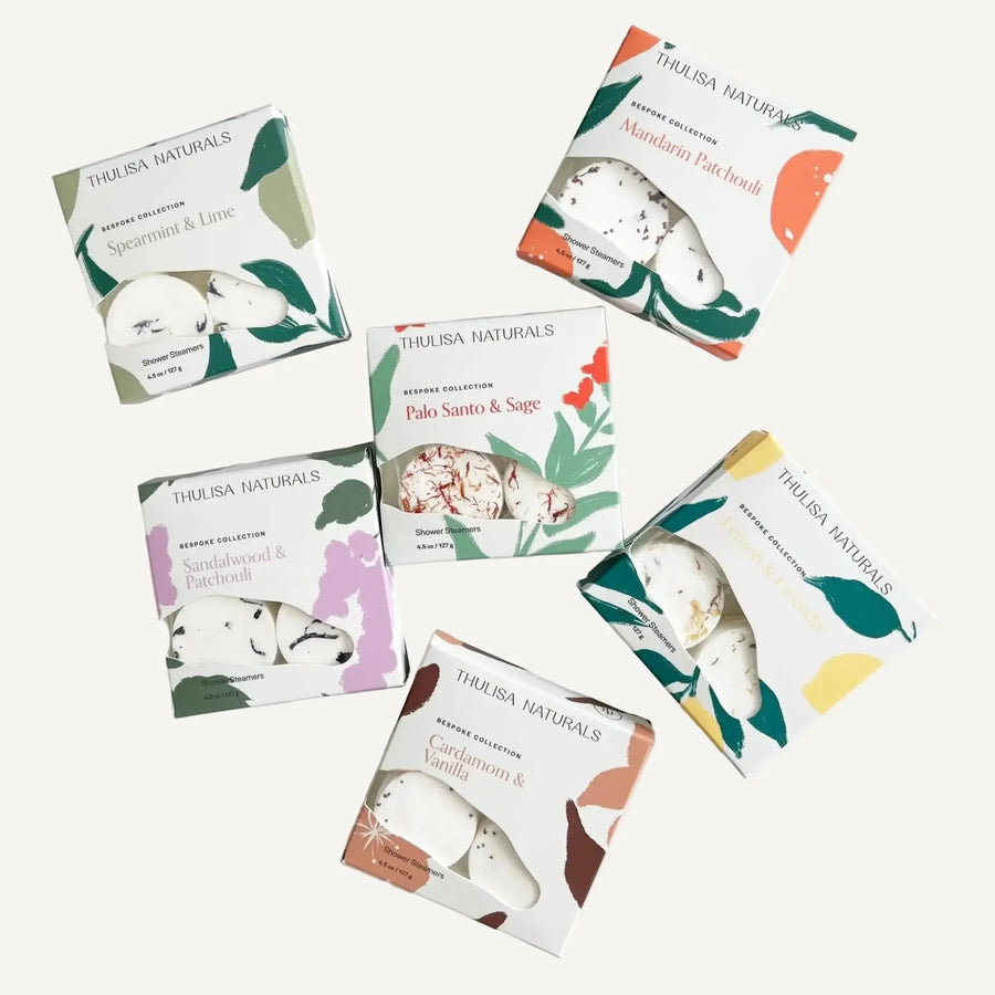 Collection of Thulisa Naturals Shower Steamer Gift boxes on a white background