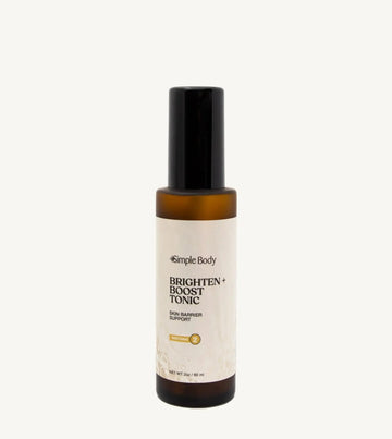 Bottle of Simple Body Brighten + Boost Tonic on a tan background