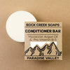 Rock Creek Soaps conditioner bar with packaging on a brown background
