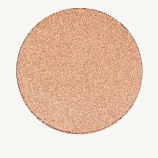 A photo of Pure Anada's Cheek Color in Afterglow which is a creamy champagne color and round.