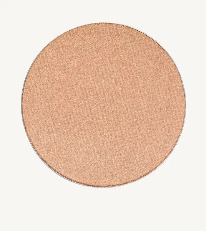 A photo of Pure Anada's Cheek Color in Afterglow which is a creamy champagne color and round.