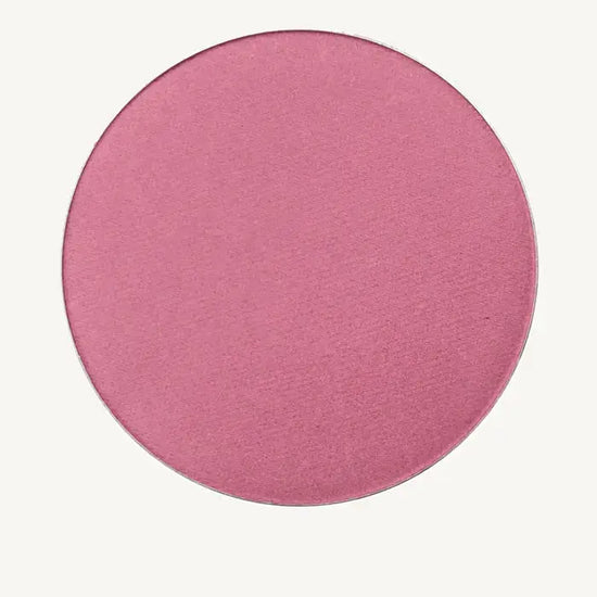 Round Rosey-Pink Shimmery Blush from Pure Anada on a tan background