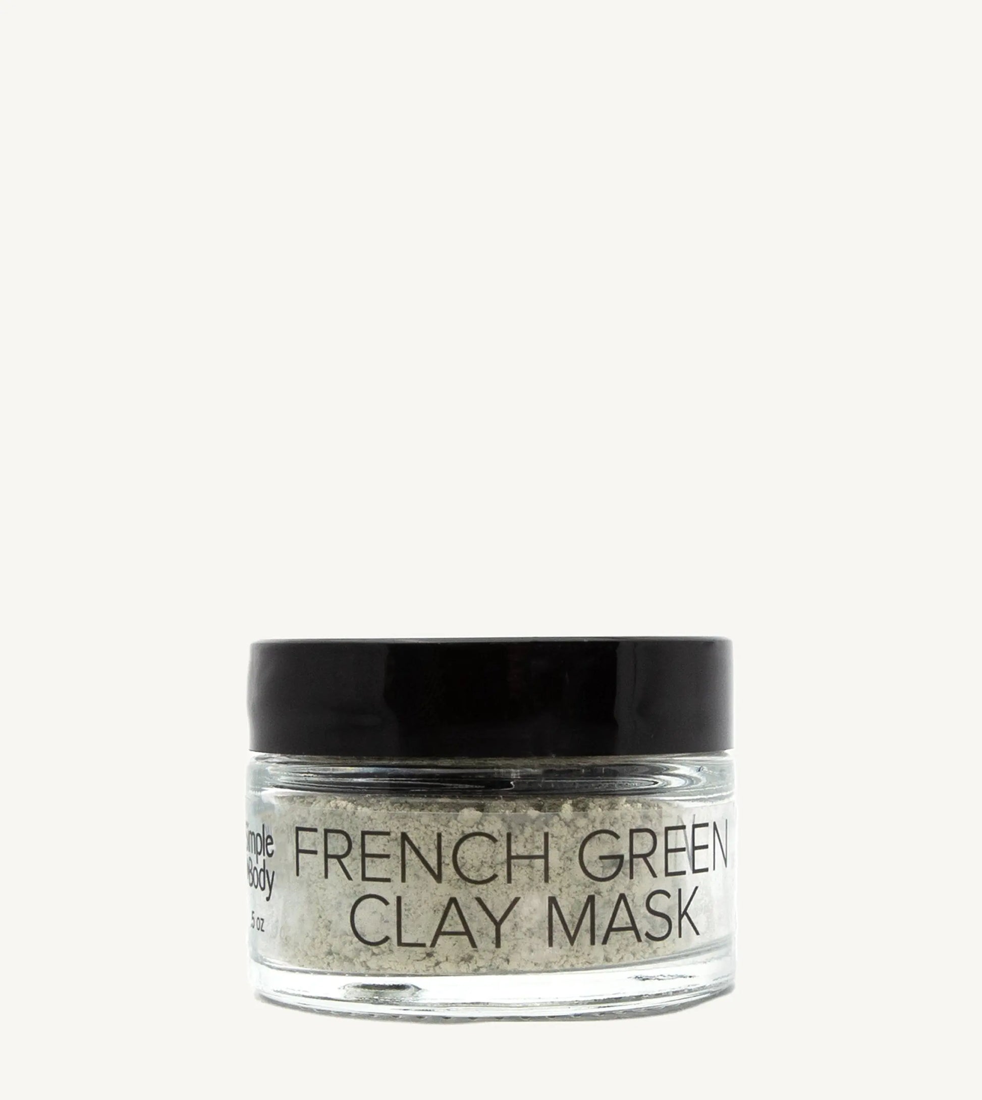 Jar of French Green Clay Mask on a tan background