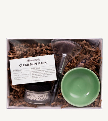 A photo of Simple ody's Clay Mask Kit which includes a recipe card, fan brush, Clay and bright green bowl packaged in a white gift box