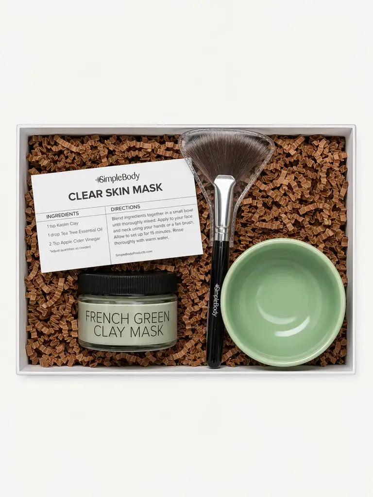 A Simple Body Clay Mask Kit with French Green Clay, a recipe card, fan brush and green bowl with kraft crinkle in a gift box.