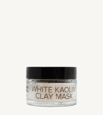 Jar of white kaolin clay mask on a white background