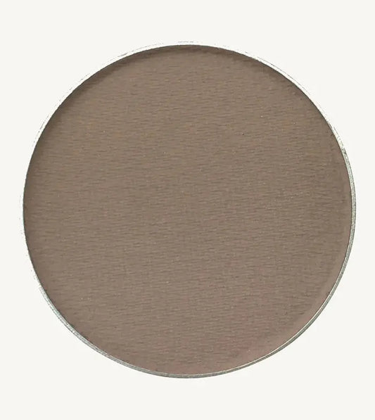 A photo of Pure Anada's Pressed Eye Shadow in Clouded which is a cool brown on a tan background.
