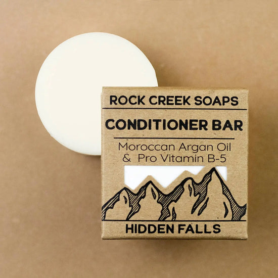 Rock Creek Soaps conditioner bar with packaging on a brown background
